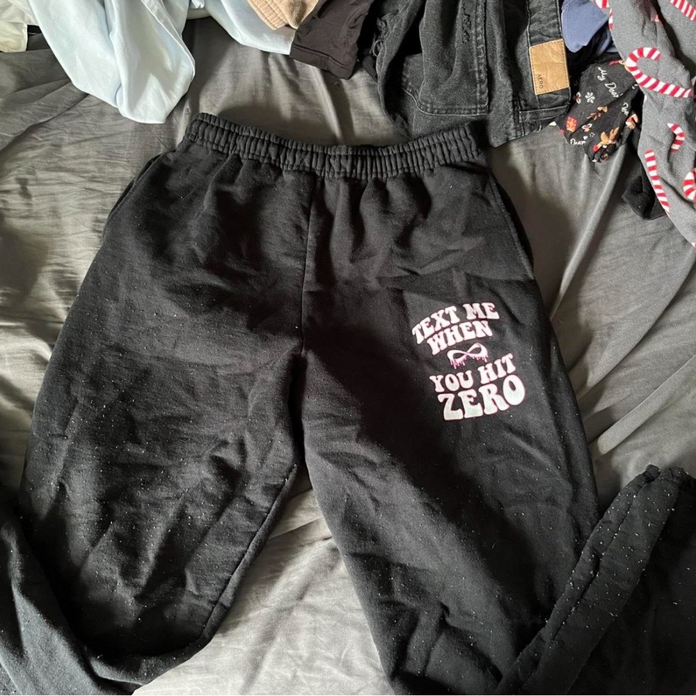 black cheerleading joggers with “text me when you hit zero” design